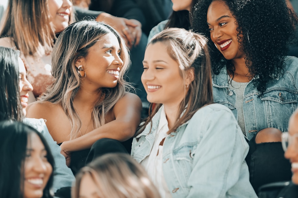 woman in white button up shirt beside woman in black tank top