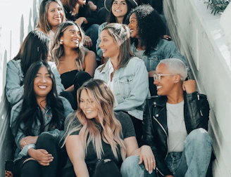 group of people sitting on gray concrete stairs