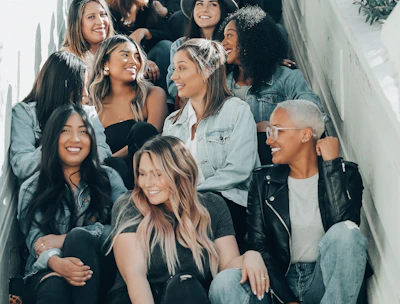 group of people sitting on gray concrete stairs