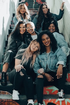 A GRUP OF WOMEN SITTIN AND SMILING
