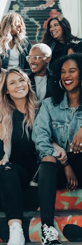 3 women sitting on red carpet