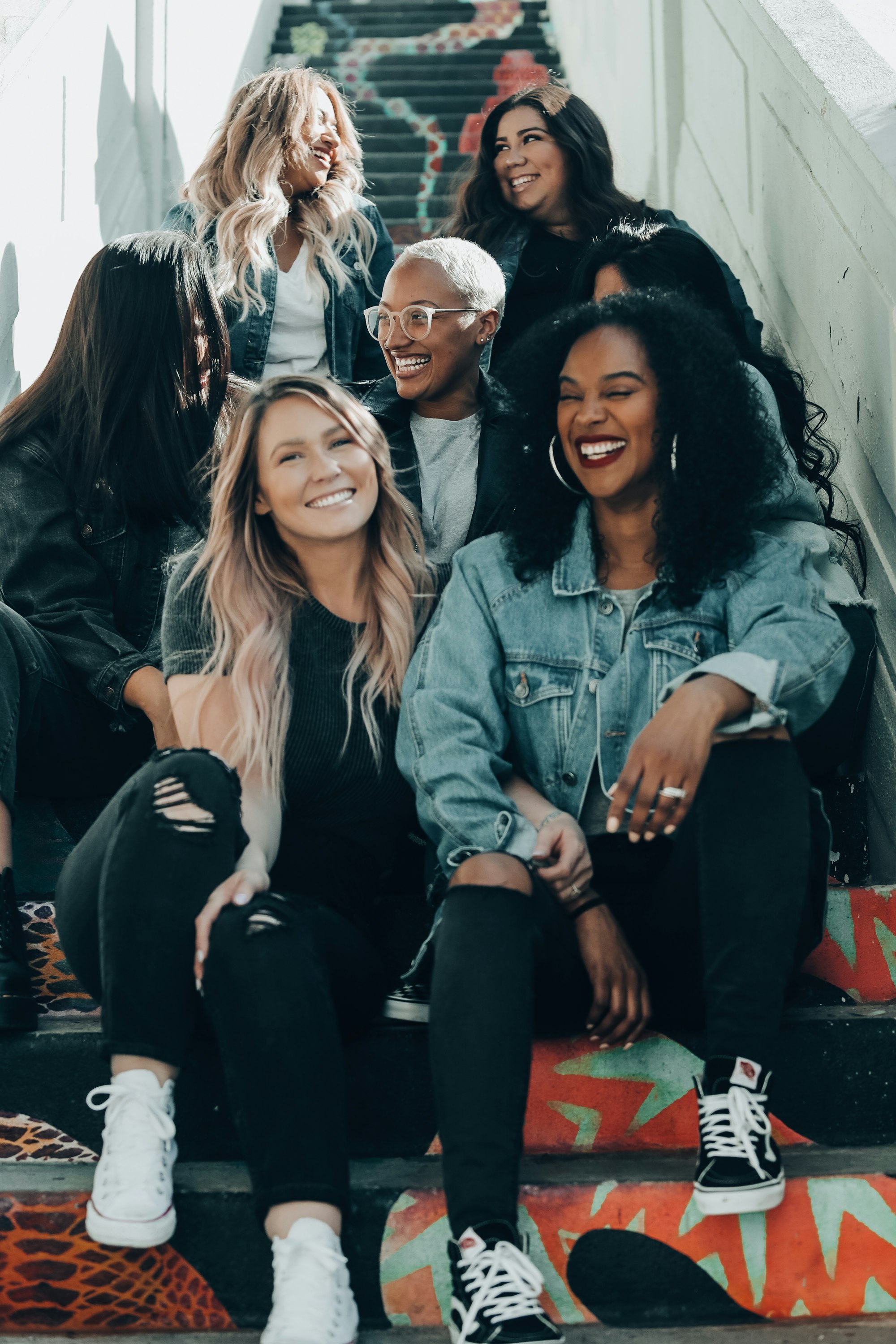 Group of curvy women sitting on steps