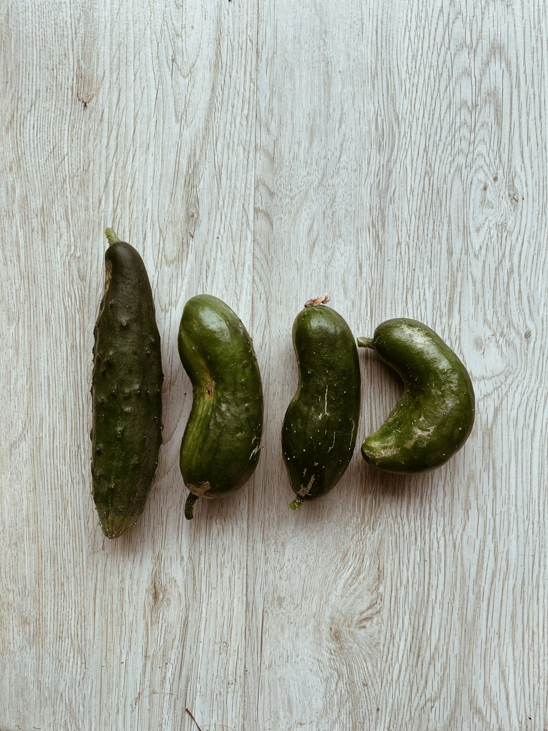 3 green chili on white wooden table