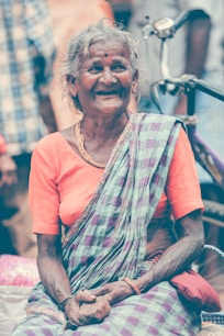 woman in orange crew neck t-shirt smiling