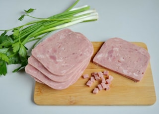 sliced ham on brown wooden chopping board