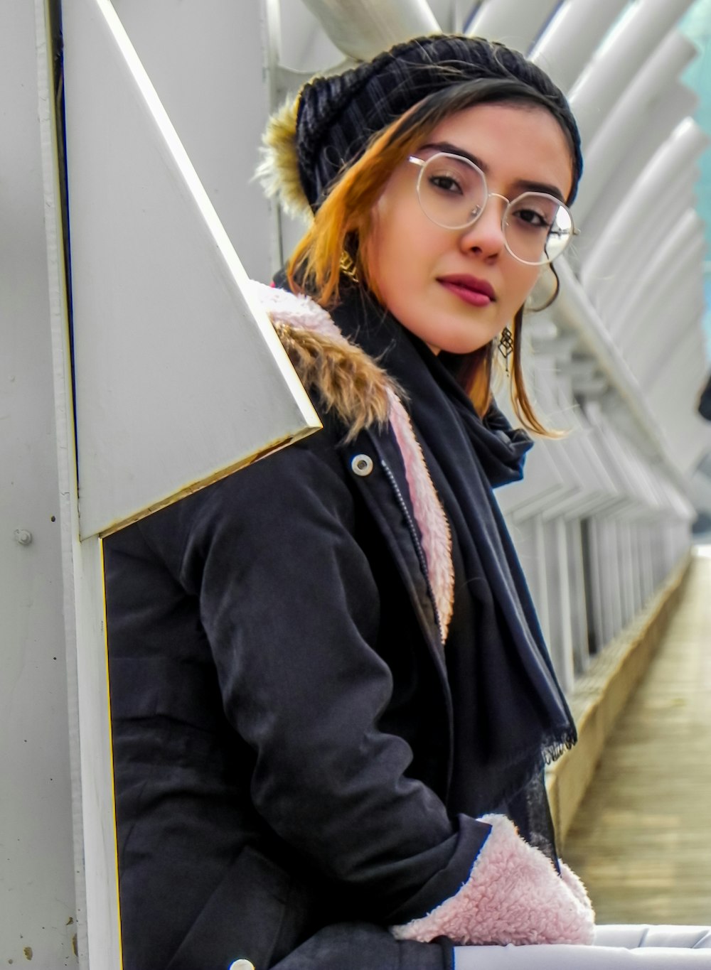 woman in black jacket wearing black framed eyeglasses