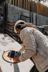 person in brown jacket wearing white helmet