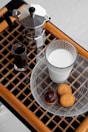 Tea and coffee maker with assorted beverages arranged neatly on a tray.