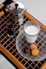 Tea and coffee maker with assorted beverages arranged neatly on a tray.