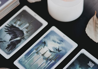 Cards and candle on black background 