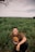 man in brown crew neck t-shirt sitting on green grass field during daytime