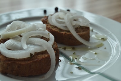 Serranito toast served on focaccia bread with fresh herbs and a side salad.