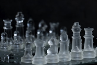 white chess piece on black surface