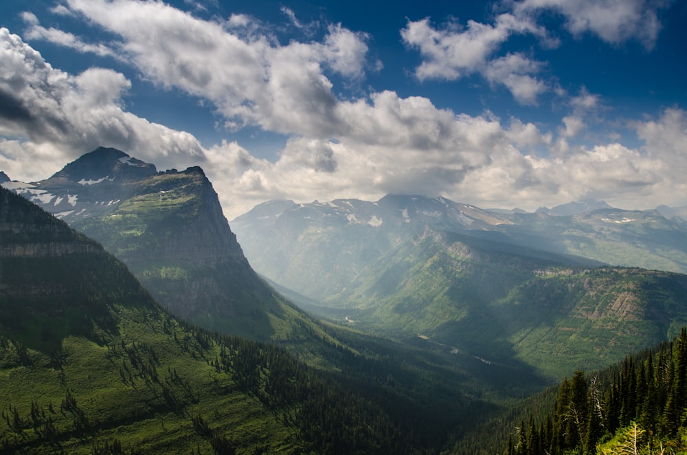 green mountains under white clouds and blue sky during daytime