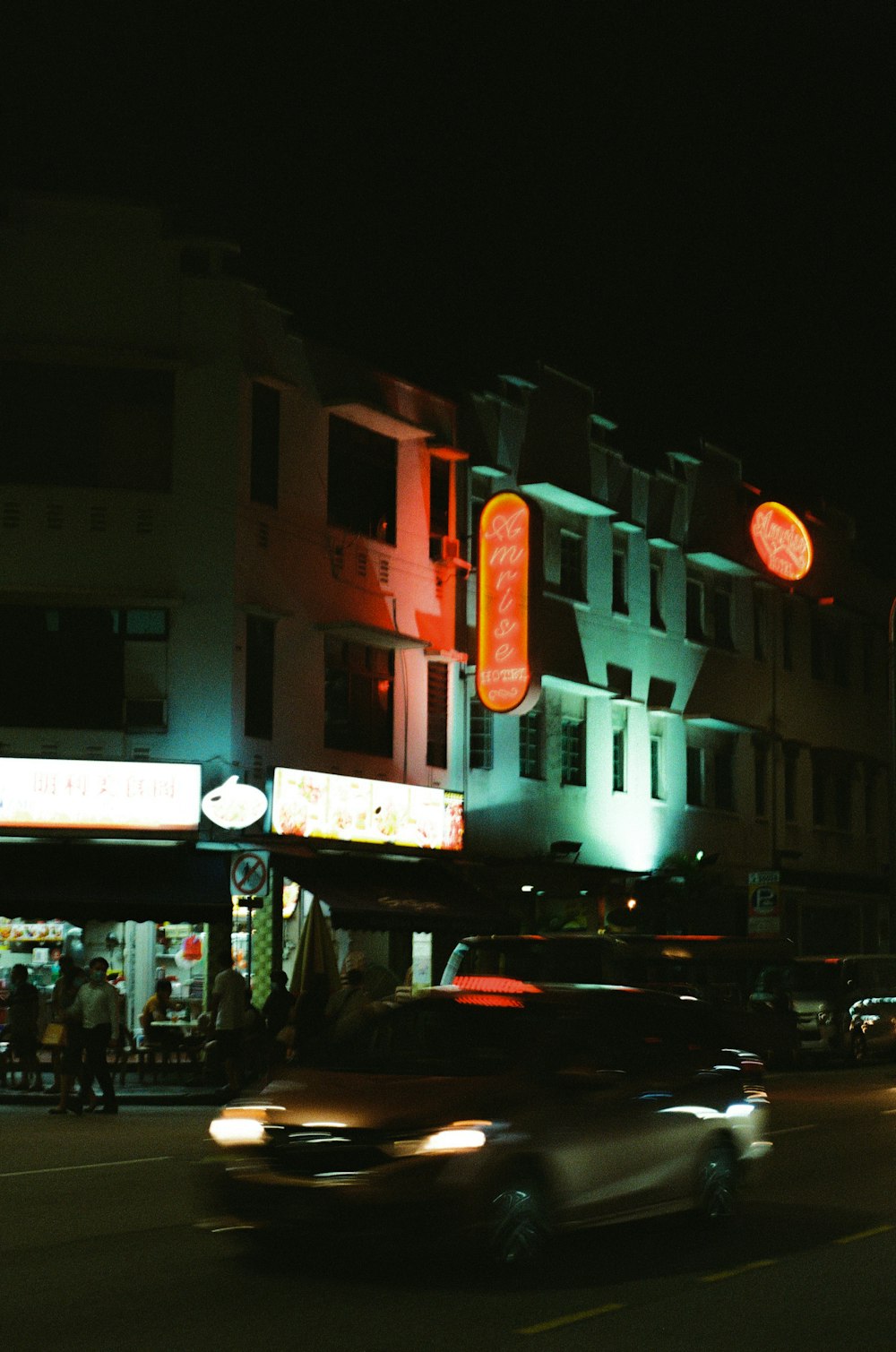 cars parked in front of building during night time