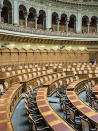 brown wooden chairs on white concrete building