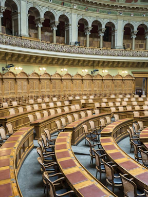 brown wooden chairs on white concrete building