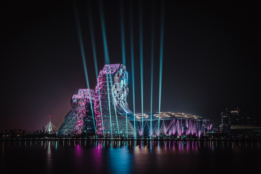 purple lighted bridge over water