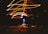 Bright streaks of light in shades of orange and blue create a dynamic pattern against a dark background. At the center, a glowing object, resembling a lamp or bulb, emits a vibrant blue hue. The light patterns loop and swirl above and around this central object.