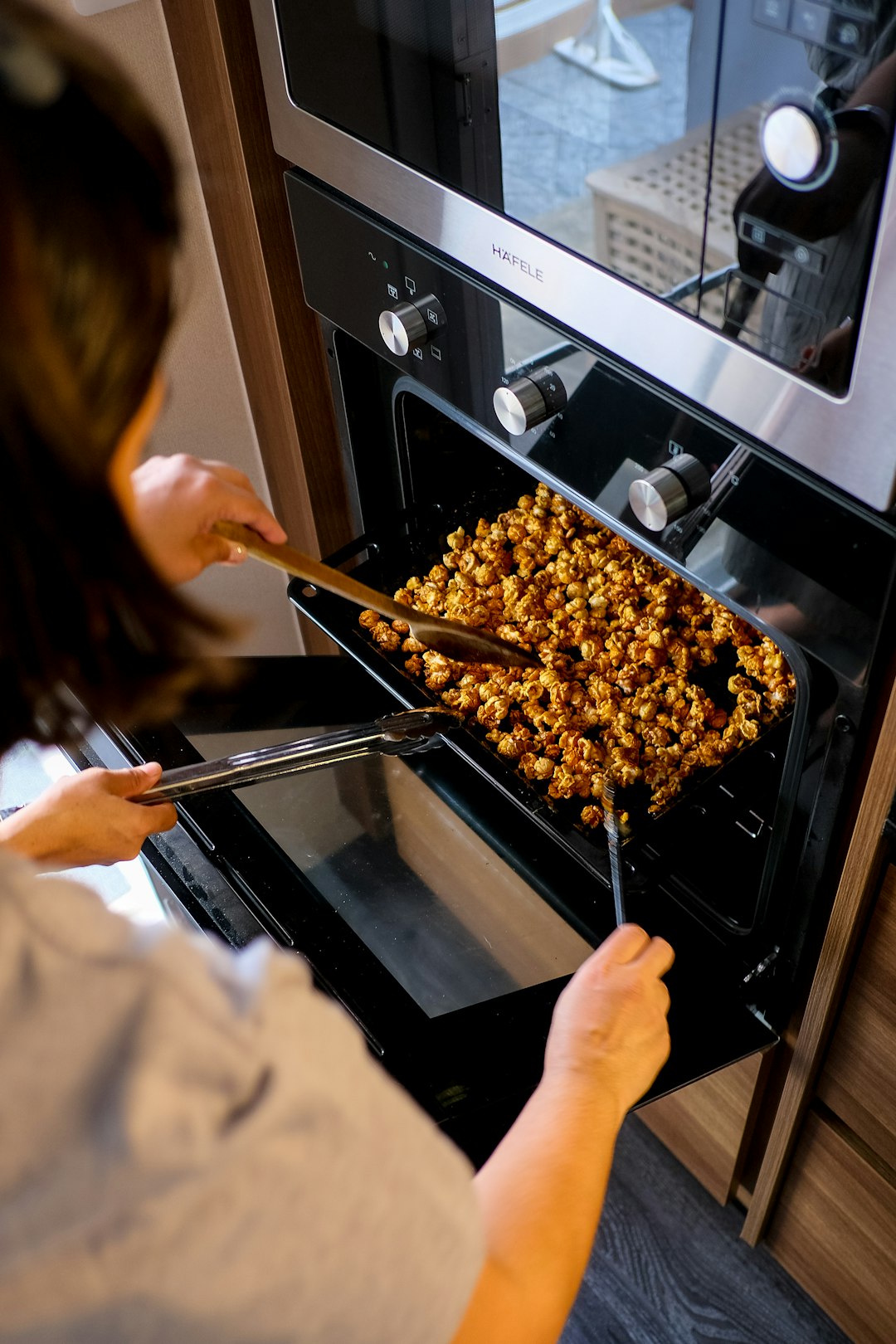  person holding brown wooden stick oven