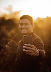 A photographer capturing a candid portrait outdoors during golden hour.