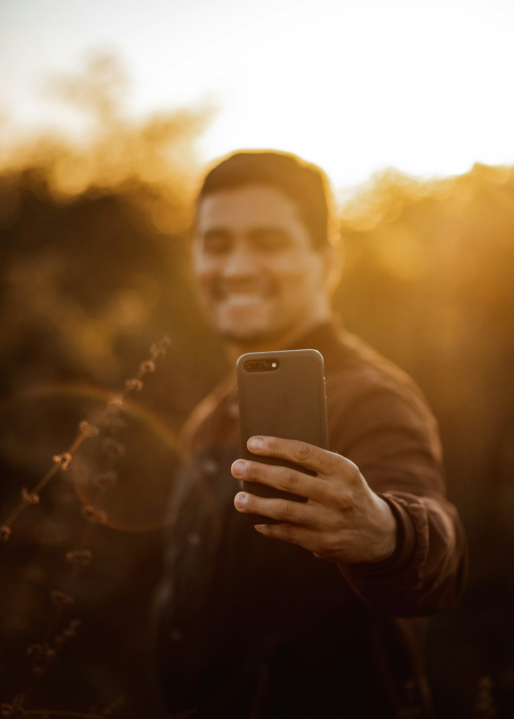 woman in gray long sleeve shirt holding white smartphone