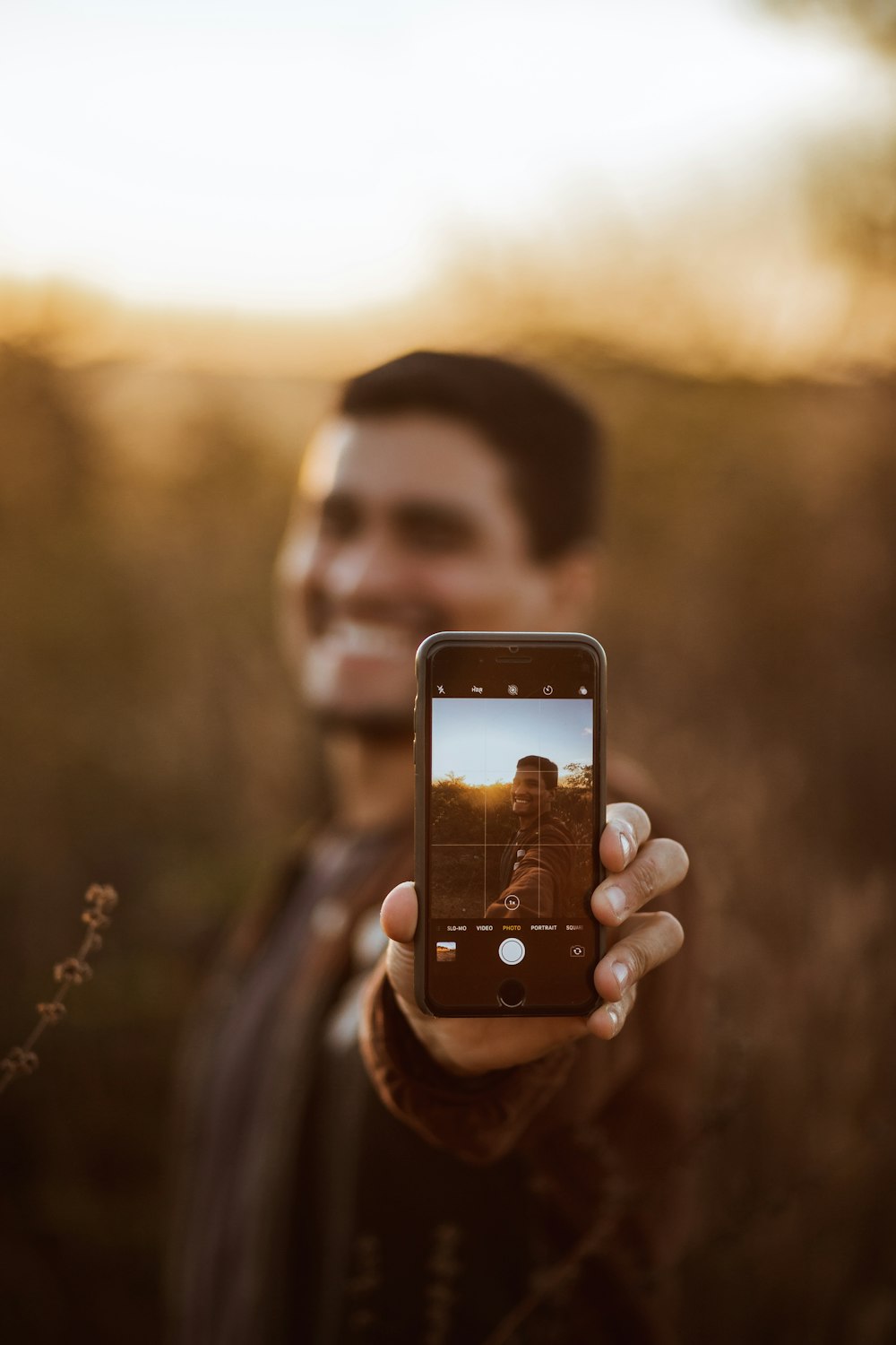 man holding black iphone 5