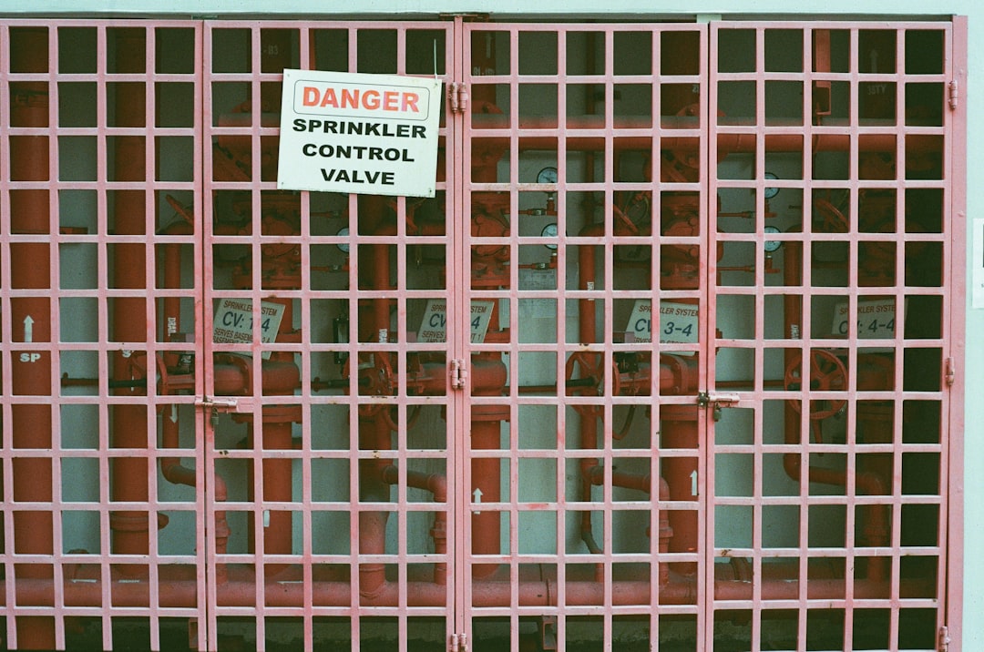 brown metal gate with white and black sign