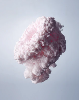 A soft lavender squishy cloud with a cute sleepy face, floating against a light pink backdrop.