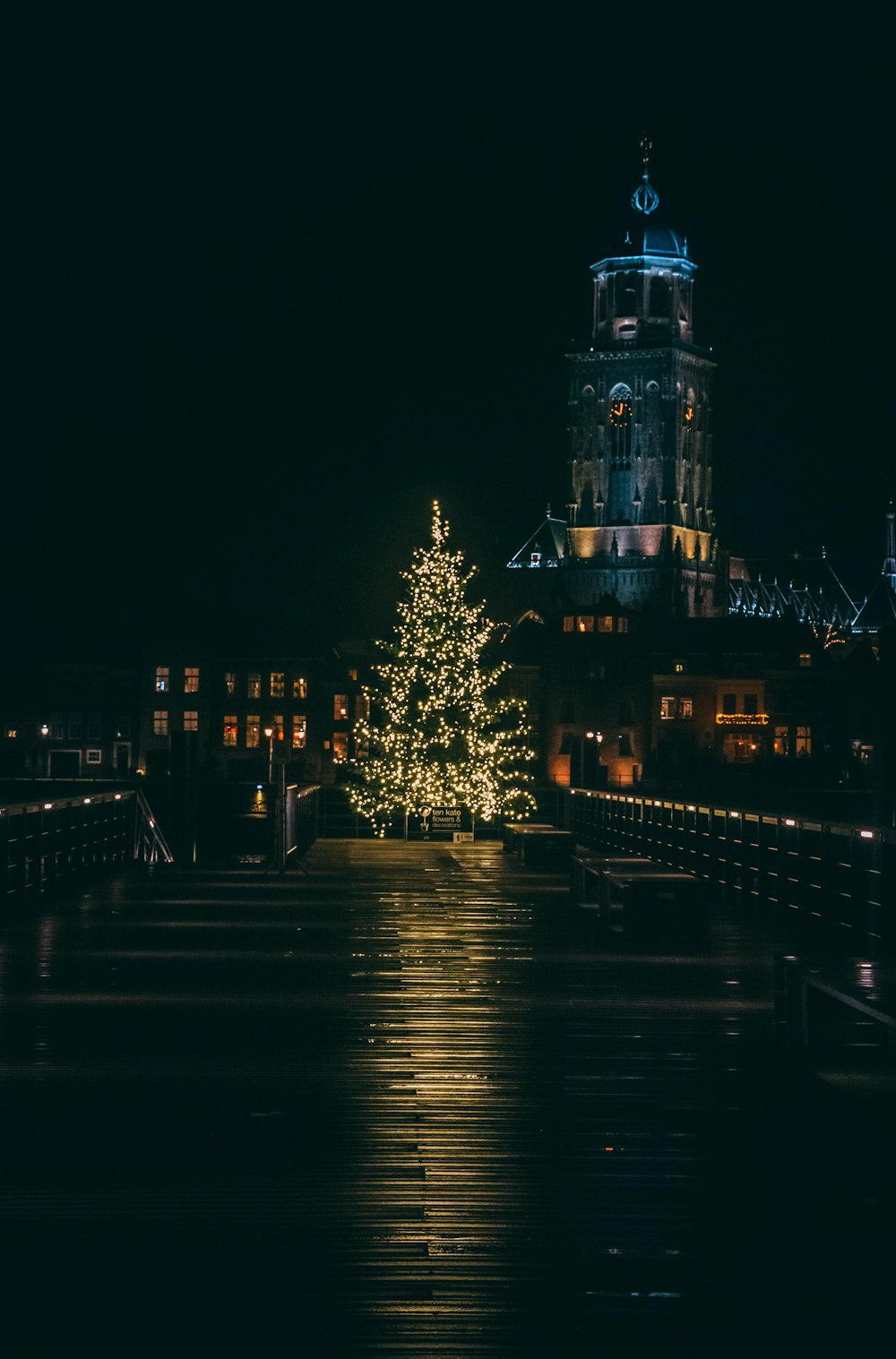 lighted building near body of water during night time