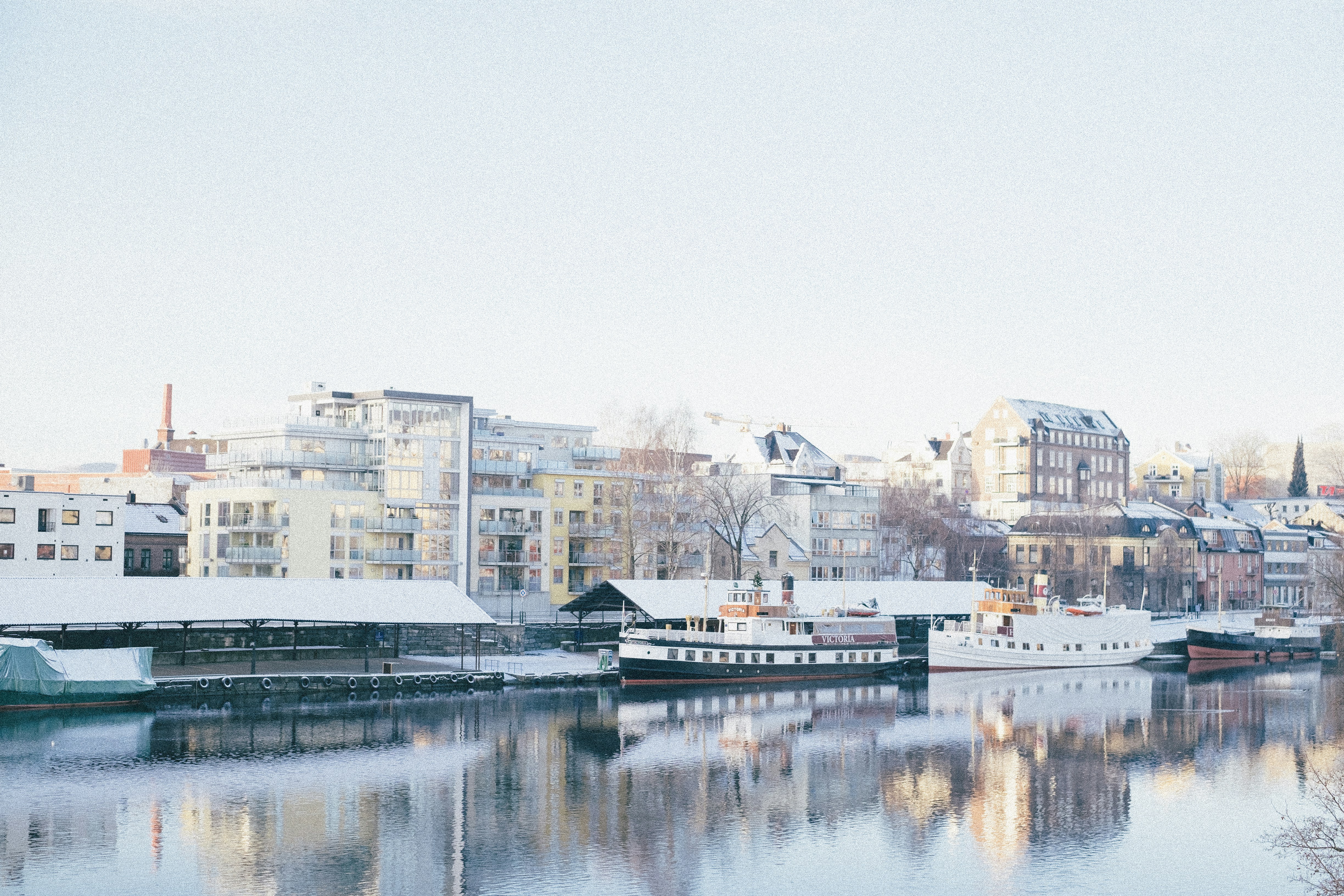 white and brown concrete building near body of water during daytime