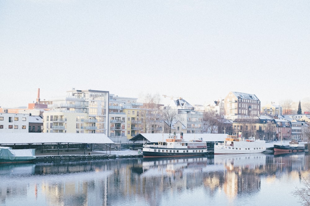 white and brown concrete building near body of water during daytime