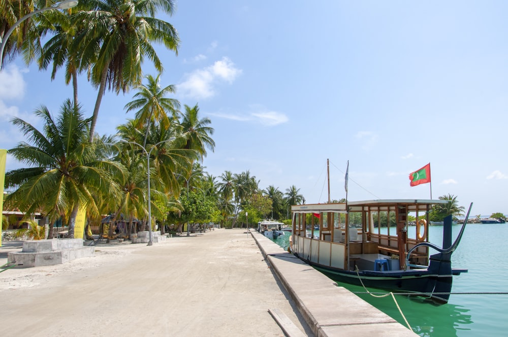 green and brown wooden boat on beach during daytime