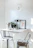 Cozy kitchen nook with a compact corner dining table and two stackable resin stools.