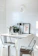 Cozy kitchen nook with a compact corner dining table and two stackable resin stools.