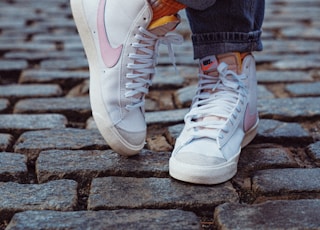 person in blue denim jeans and white nike sneakers