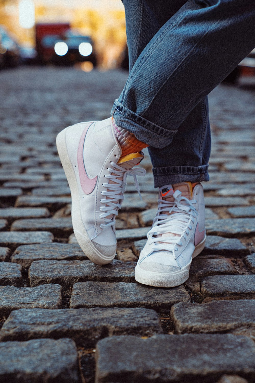 person in blue denim jeans and white nike sneakers