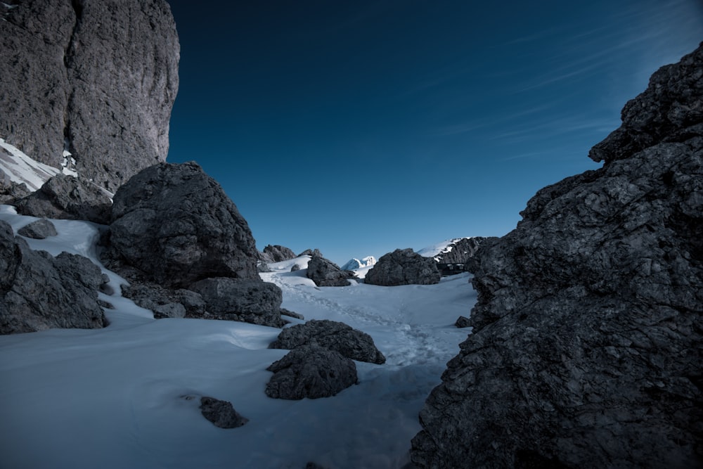 rocky mountain with snow under blue sky during daytime