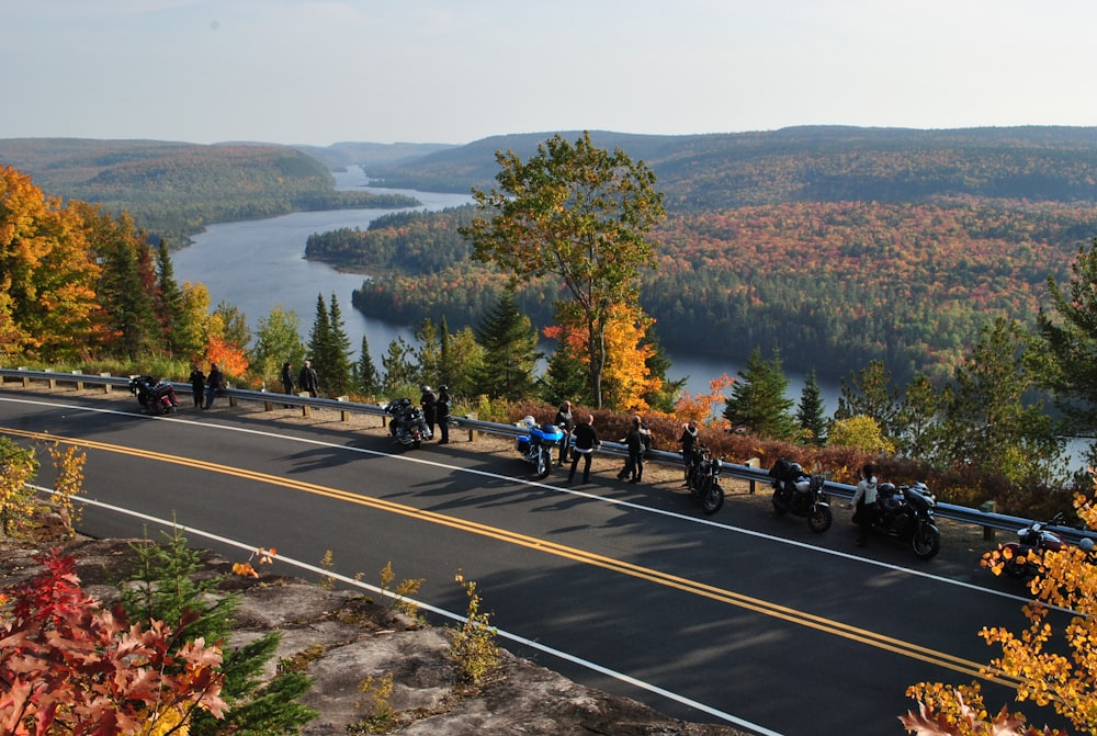 people riding motorcycle on road during daytime