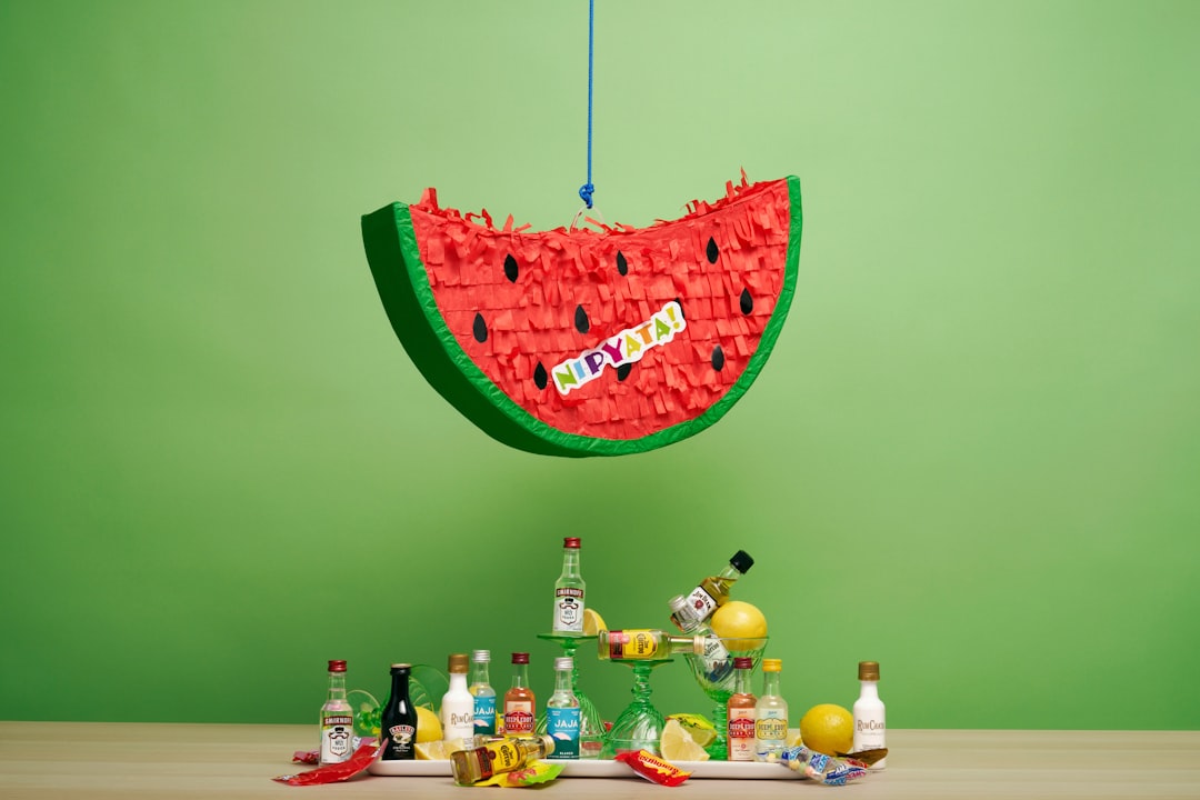 green and pink heart shaped wall decor, A watermelon piñata filled with mini plastic bottles of the best liquor and cand