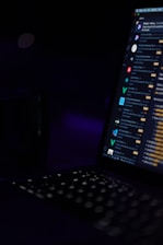 black laptop computer turned on showing desktop