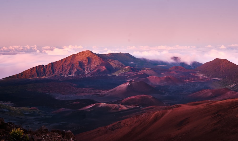 brown and black mountains under white clouds during daytime