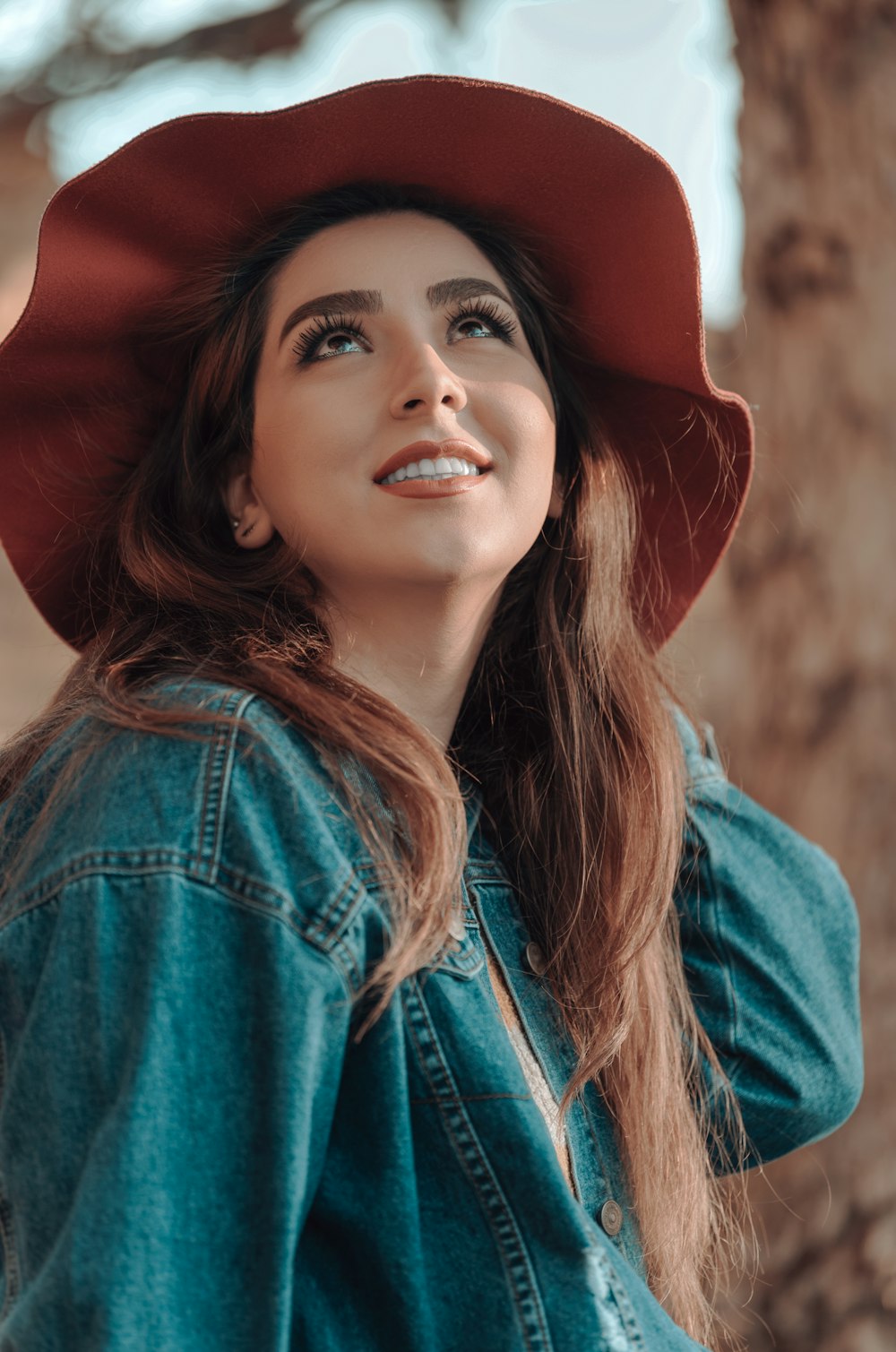 woman in blue denim jacket wearing red hat