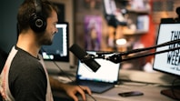 man in gray collared shirt wearing black headphones