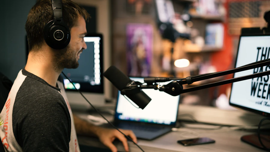 A man in a recording studio wearing headphones at a producer's desk