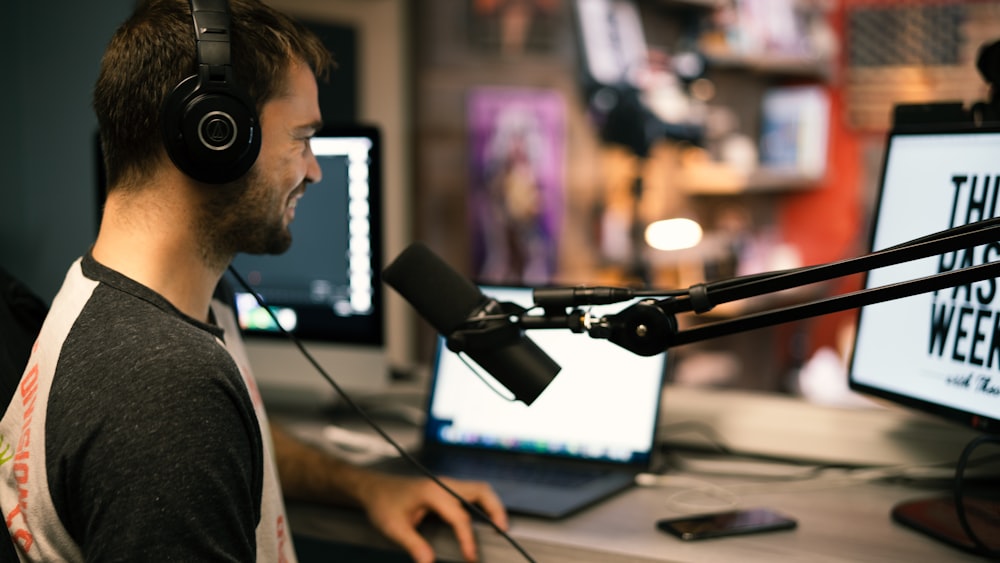 man in gray collared shirt wearing black headphones