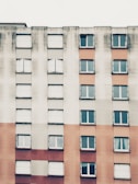 Close-up of a high-rise apartment building facade featuring off-white and navy colors