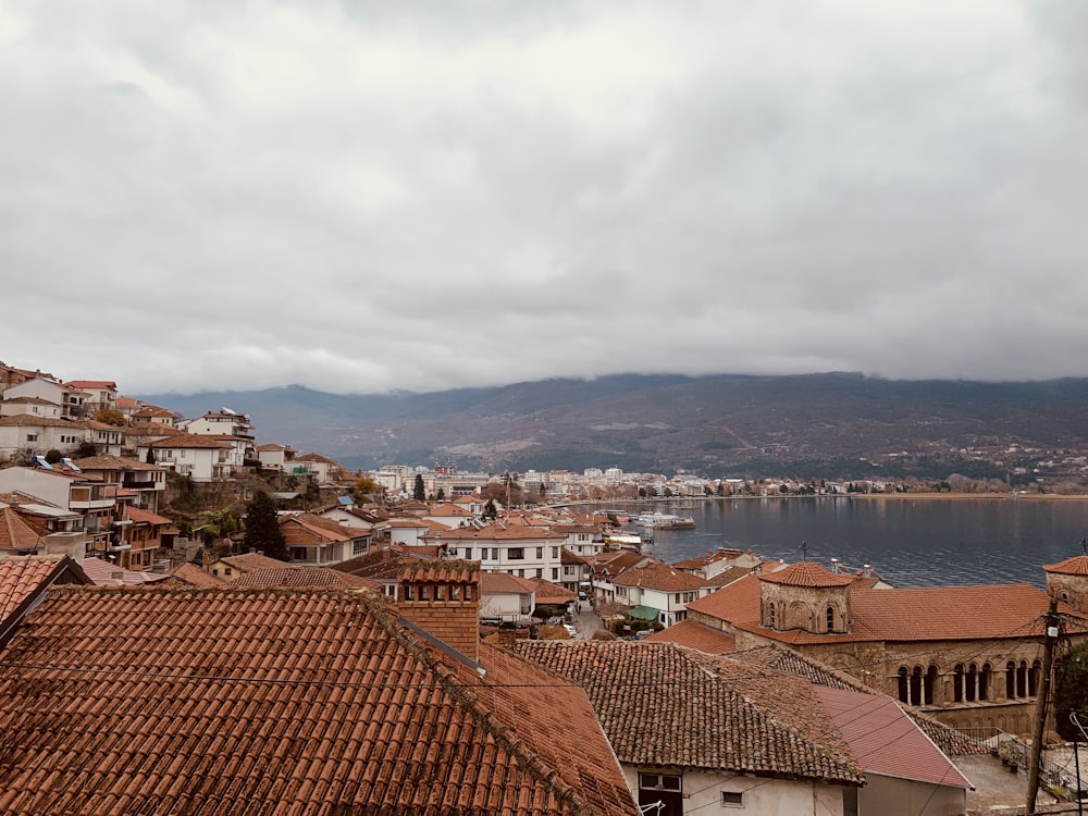 brown and white concrete houses near body of water during daytime