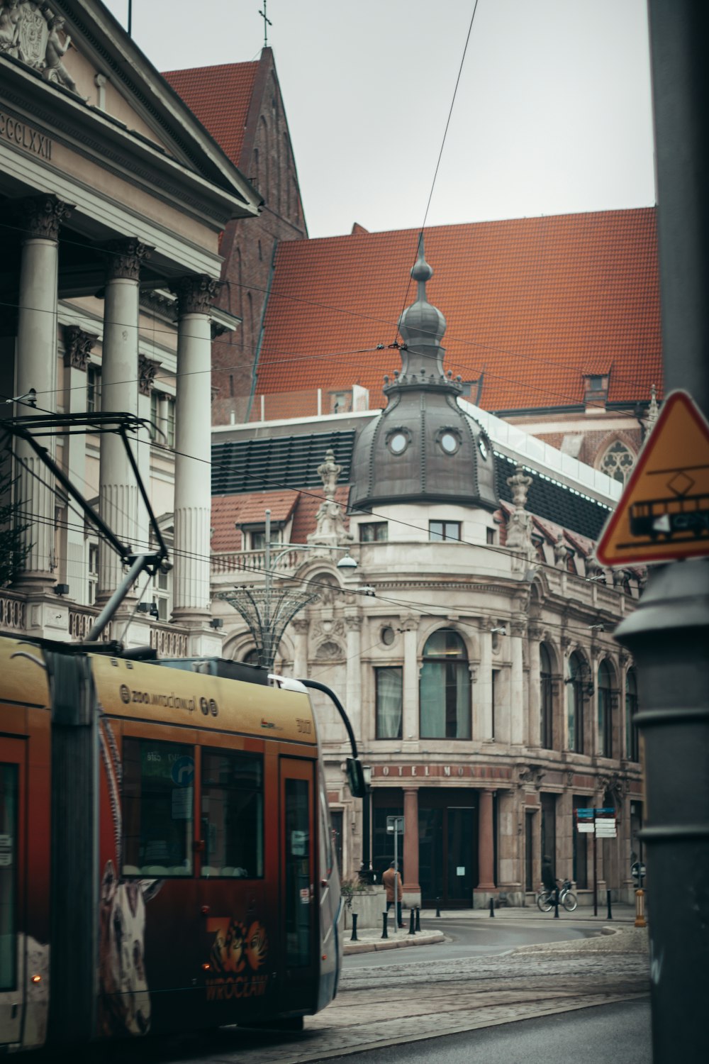 red and white tram on road near building during daytime