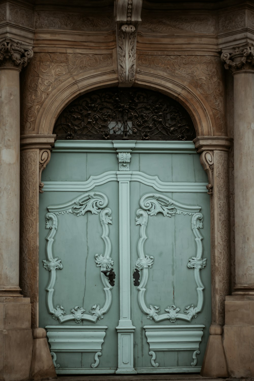 brown wooden door with green steel door